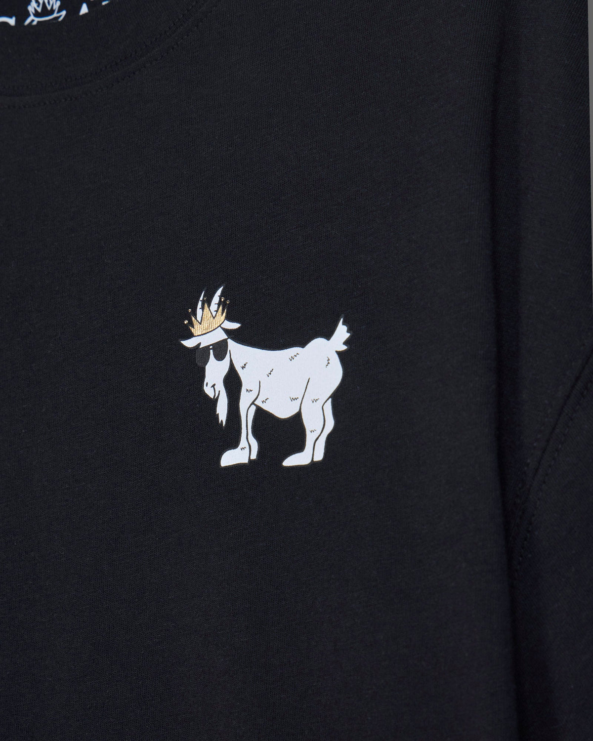 Close-up of black oversized crop top with white goat design