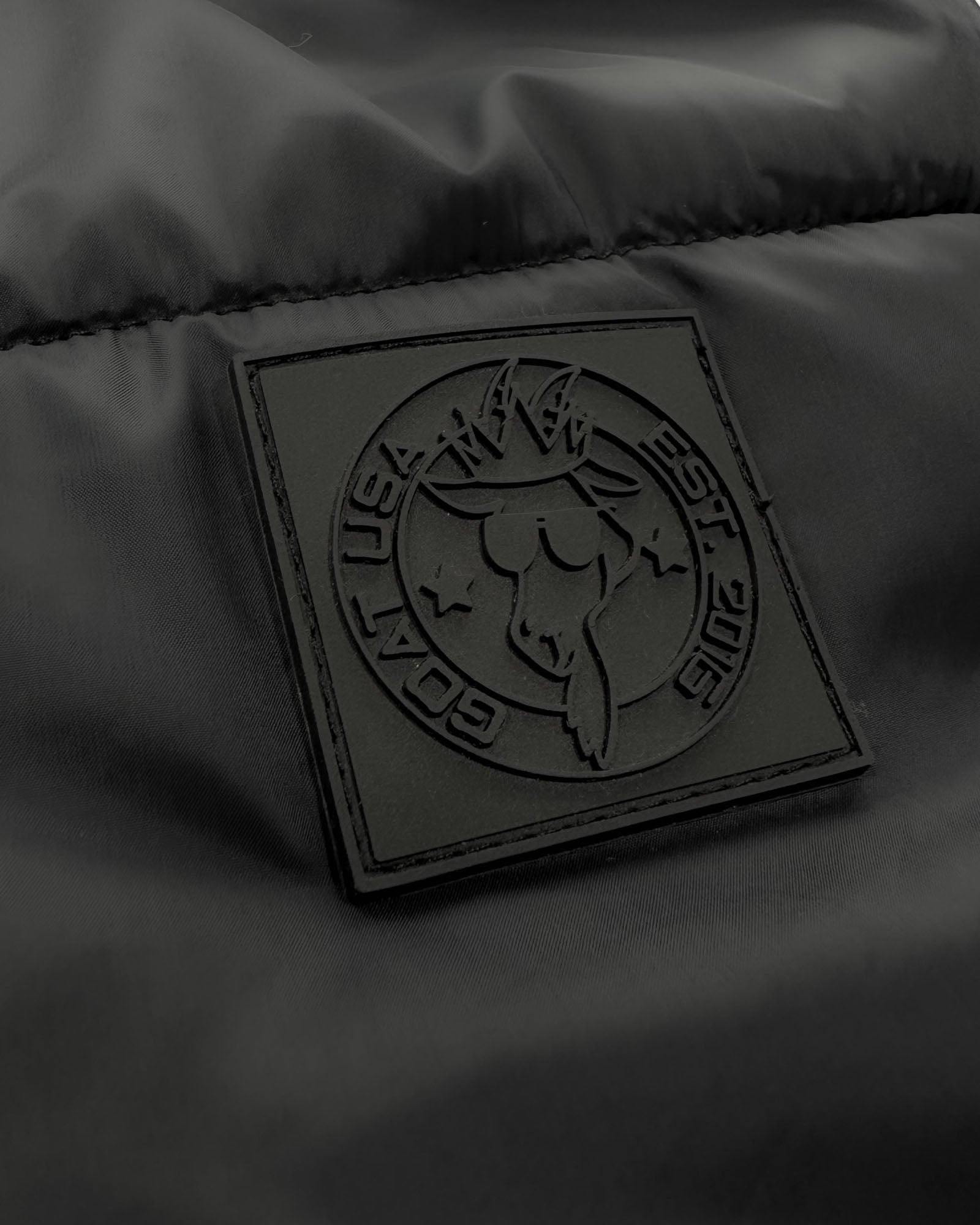 Close up of patch on black Women's Puffer Fleece Vest#color_black