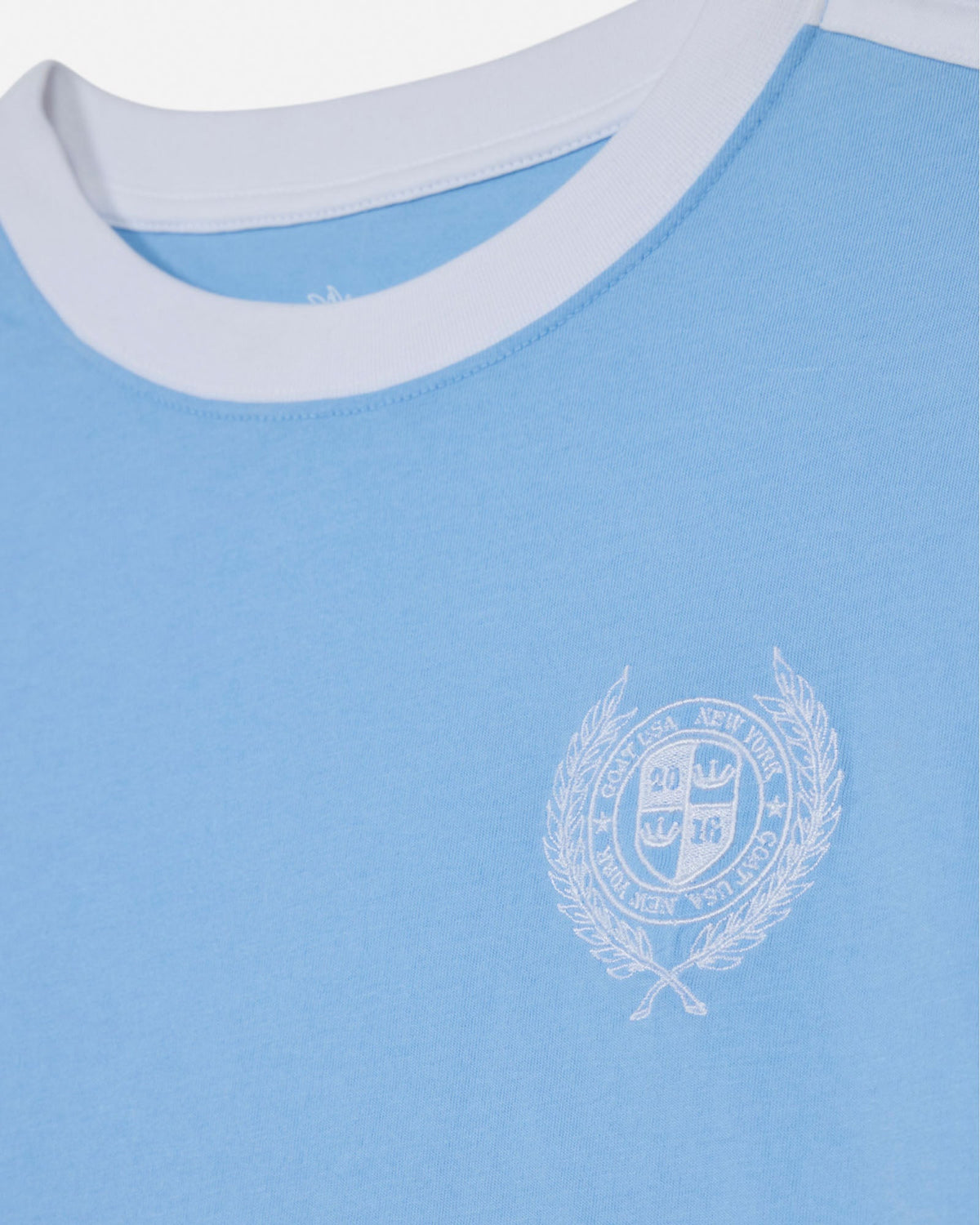 Light blue shirt with a white emblem on a white background#color_carolina-blue