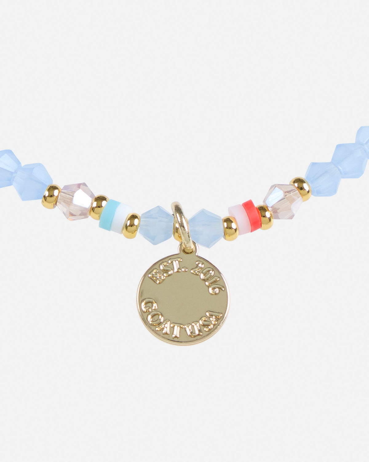 Bracelet with colorful beads and a gold charm on a white background