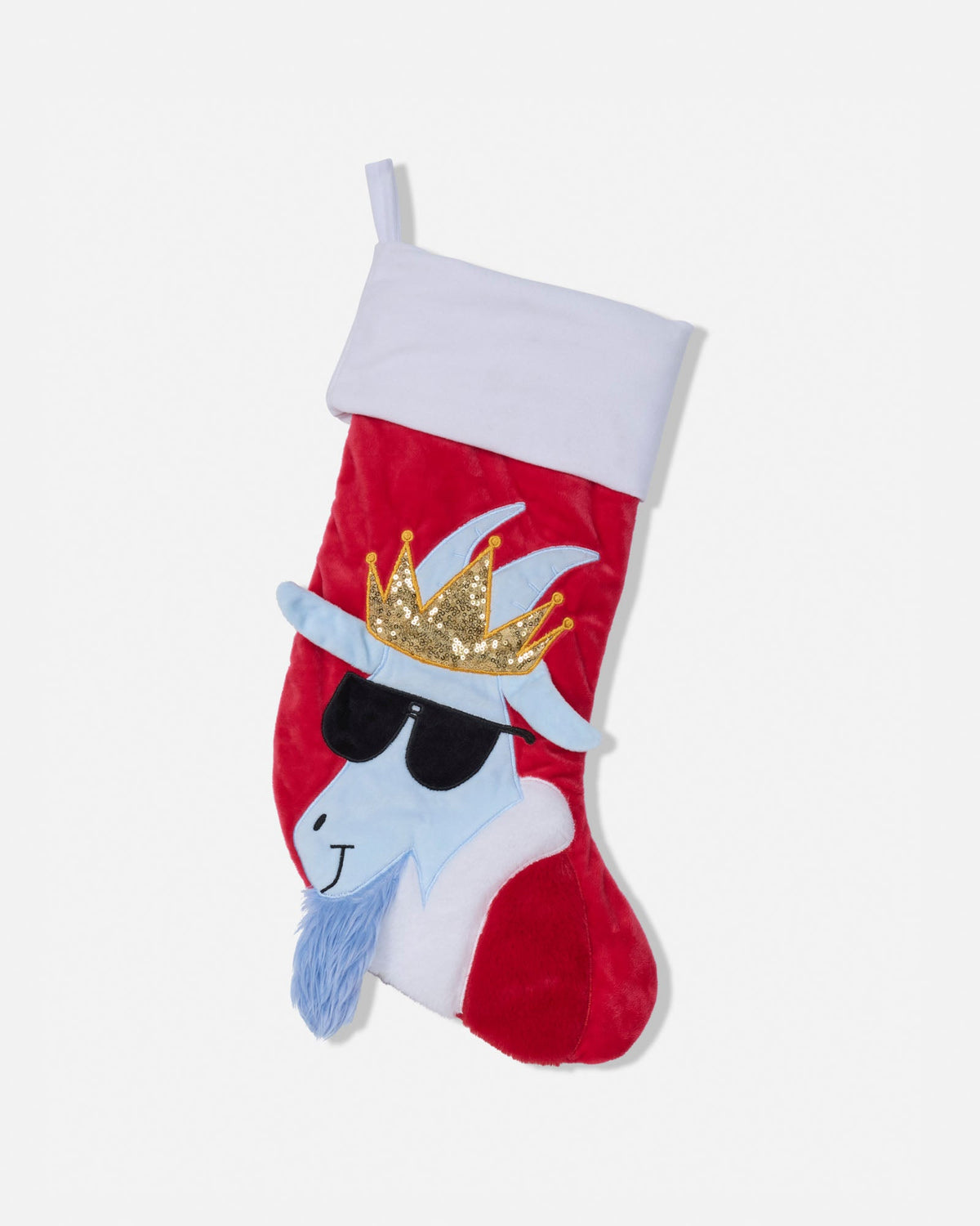 A red Christmas stocking with a white cuff, featuring a stylized blue goat character wearing a gold sequined crown and black sunglasses.