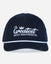 A dark navy blue corduroy baseball cap with white embroidered text reading 'The Greatest Goat USA Established 2016' on the front, featuring a white piping accent along the brim.