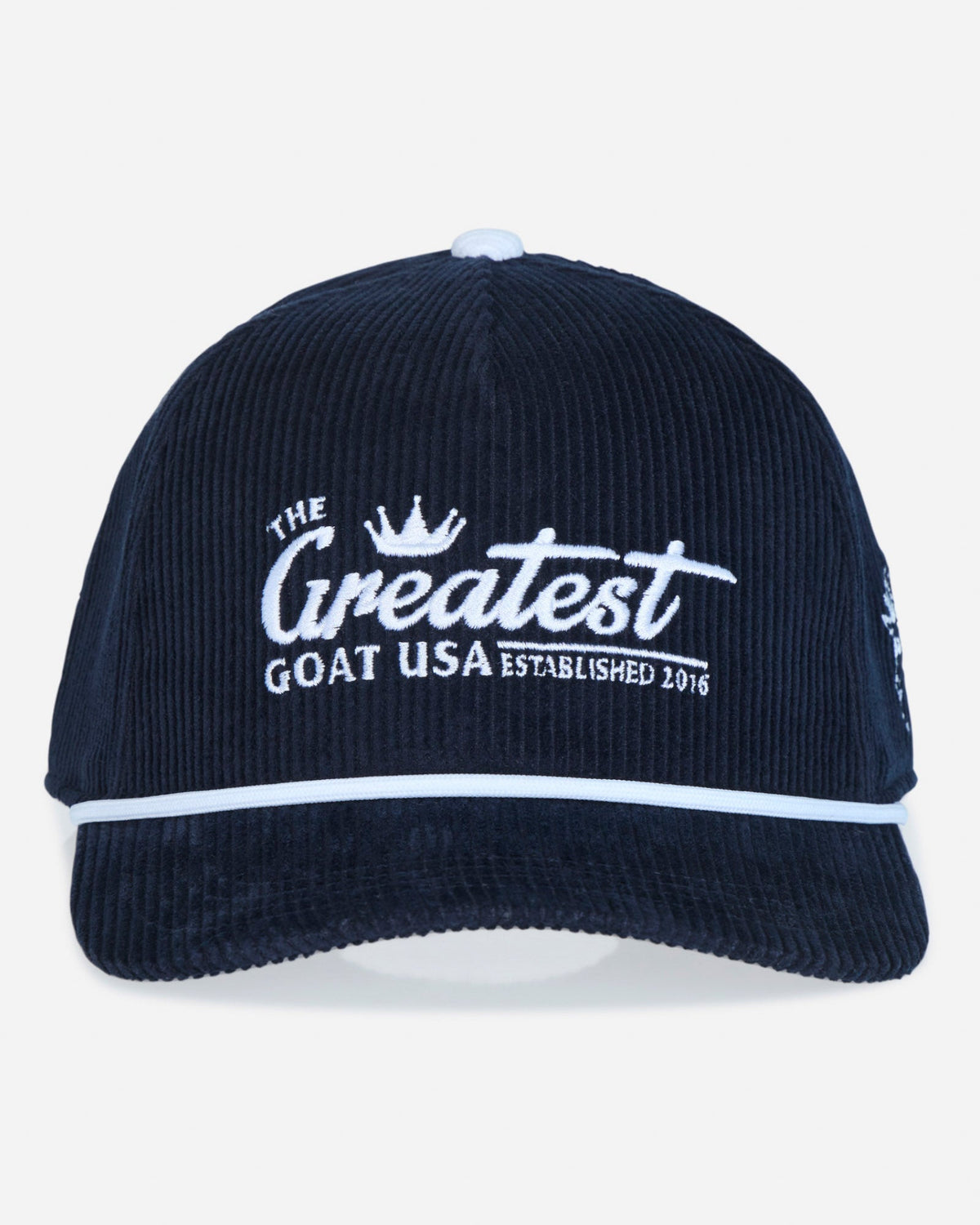 A dark navy blue corduroy baseball cap with white embroidered text reading 'The Greatest Goat USA Established 2016' on the front, featuring a white piping accent along the brim.