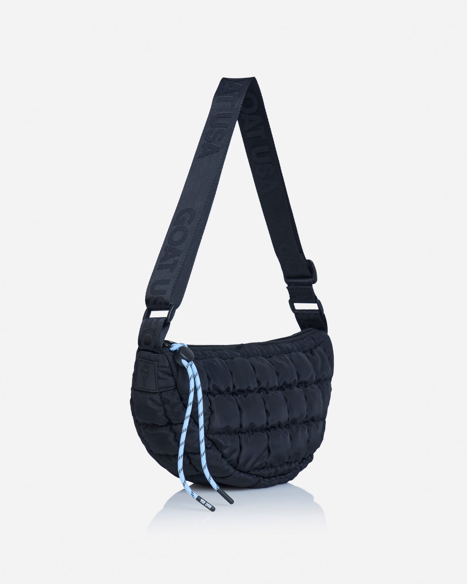Angled view of black sling bag