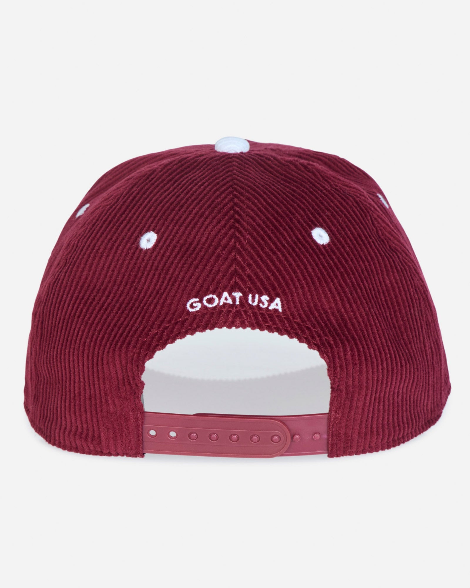 The back of a burgundy corduroy baseball cap featuring 'GOAT USA' embroidered in white on the crown, with a matching burgundy snapback closure and white ventilation eyelets.