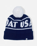 A navy blue knit beanie with a white pom-pom on top. The beanie features white knit lettering that reads 'GOAT USA' across the front, with a ribbed cuff at the bottom.
