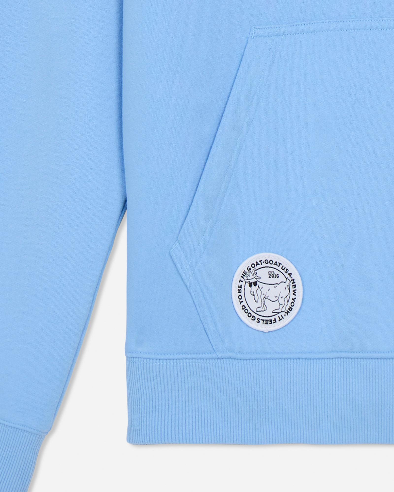 Light blue sweatshirt with a white logo on a light gray background