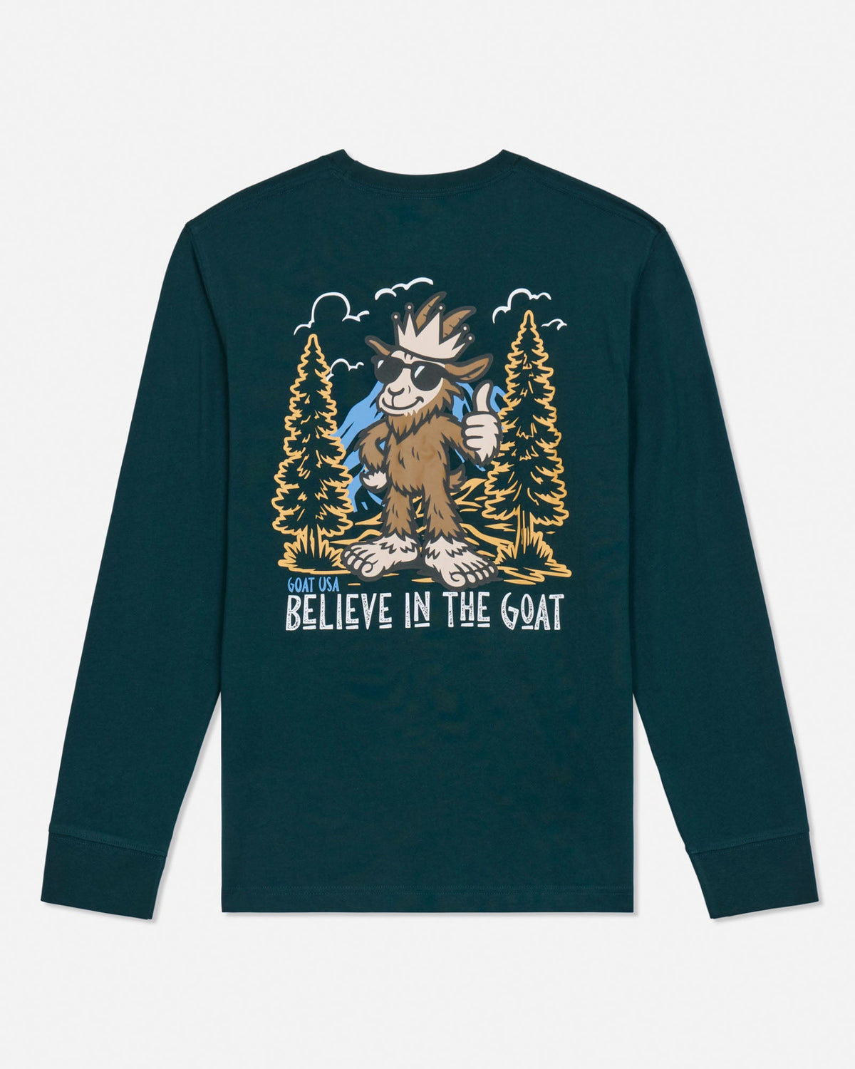 A dark teal long-sleeve t-shirt with a large graphic print on the front featuring a cartoon goat in a forest with the text 'GOAT USA BELIEVE IN THE GOAT'.