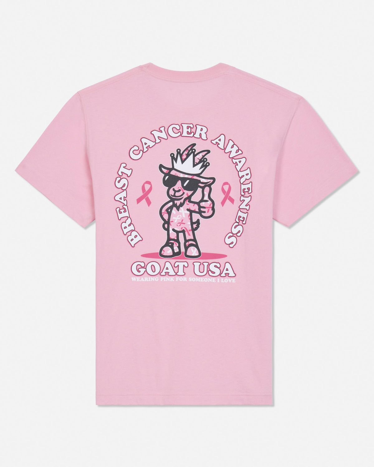 A light pink short-sleeve t-shirt shown from the back, featuring a large graphic print of a cartoon goat wearing sunglasses and a hat, surrounded by the text 'BREAST CANCER AWARENESS' and 'GOAT USA' with pink ribbons.