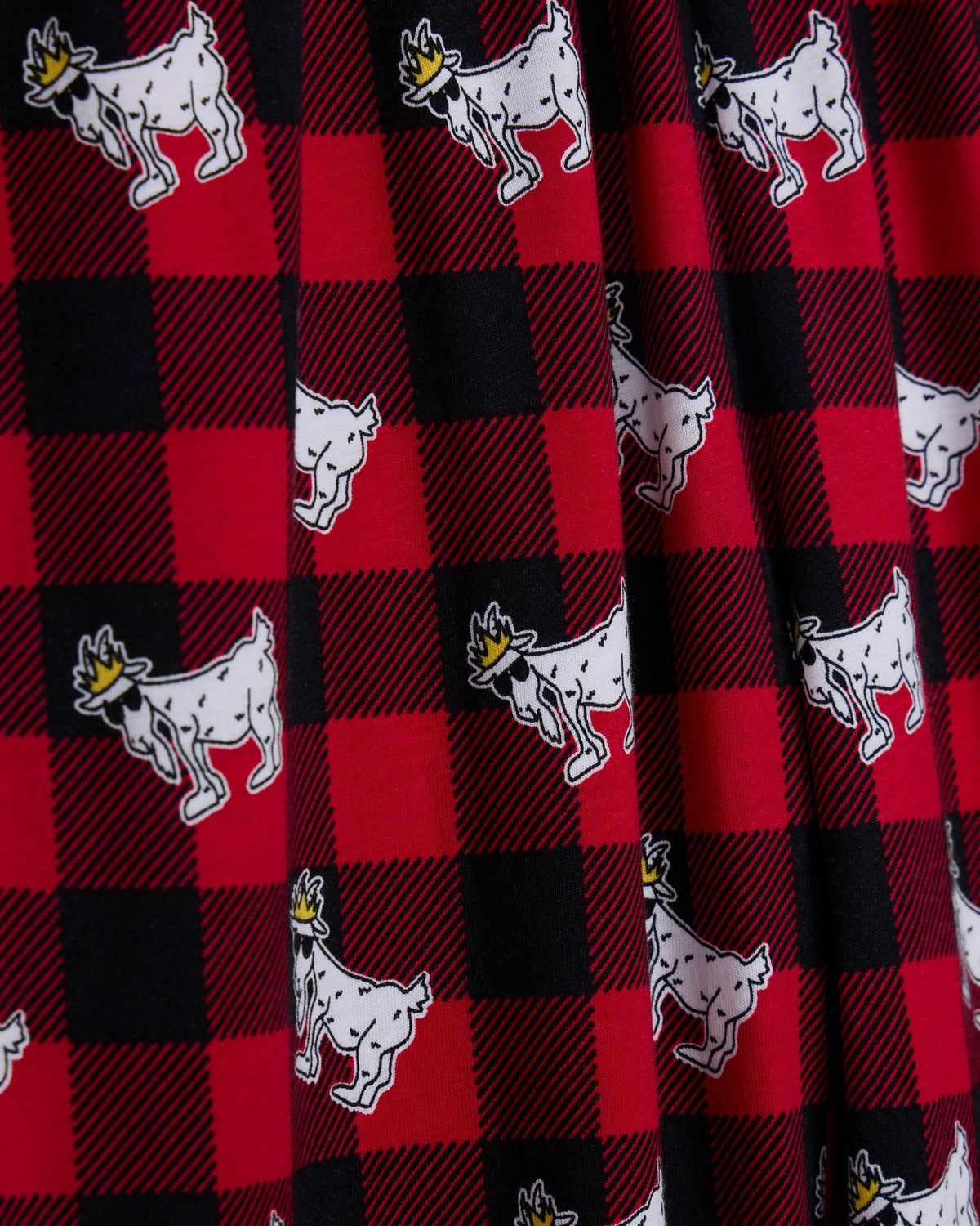 Flannel fabric with red and black check pattern and white goat illustration.