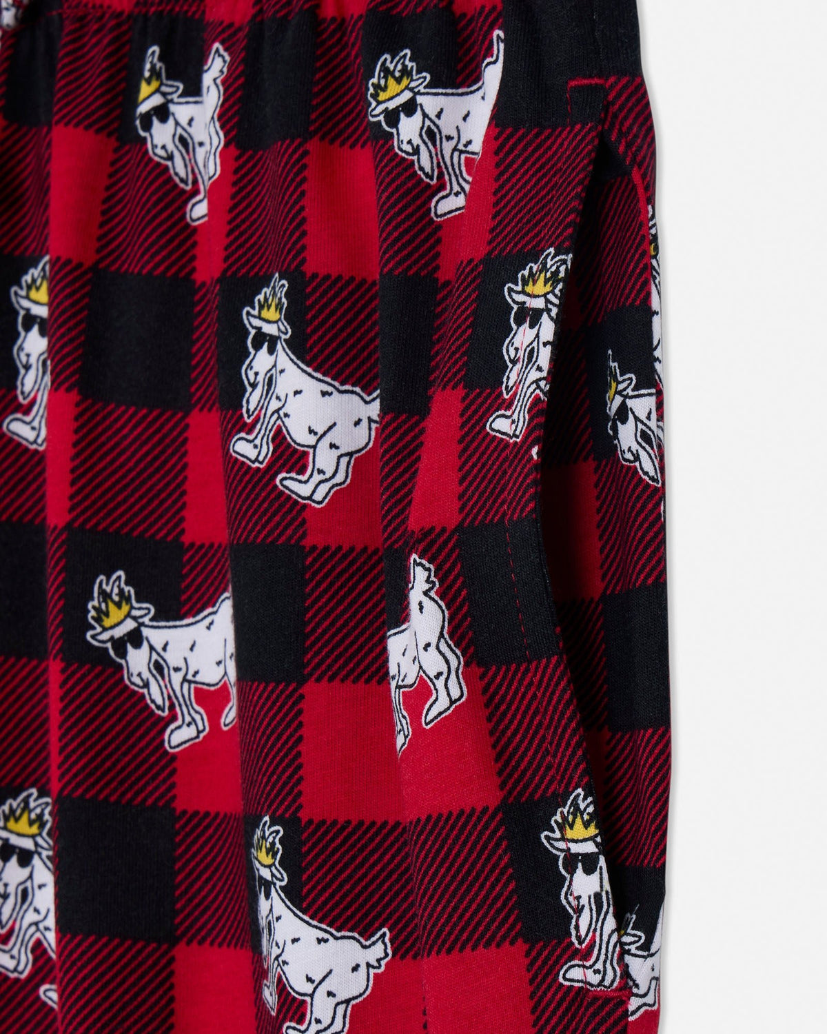 Plaid fabric with cartoon goat pattern on a red and black checkered background