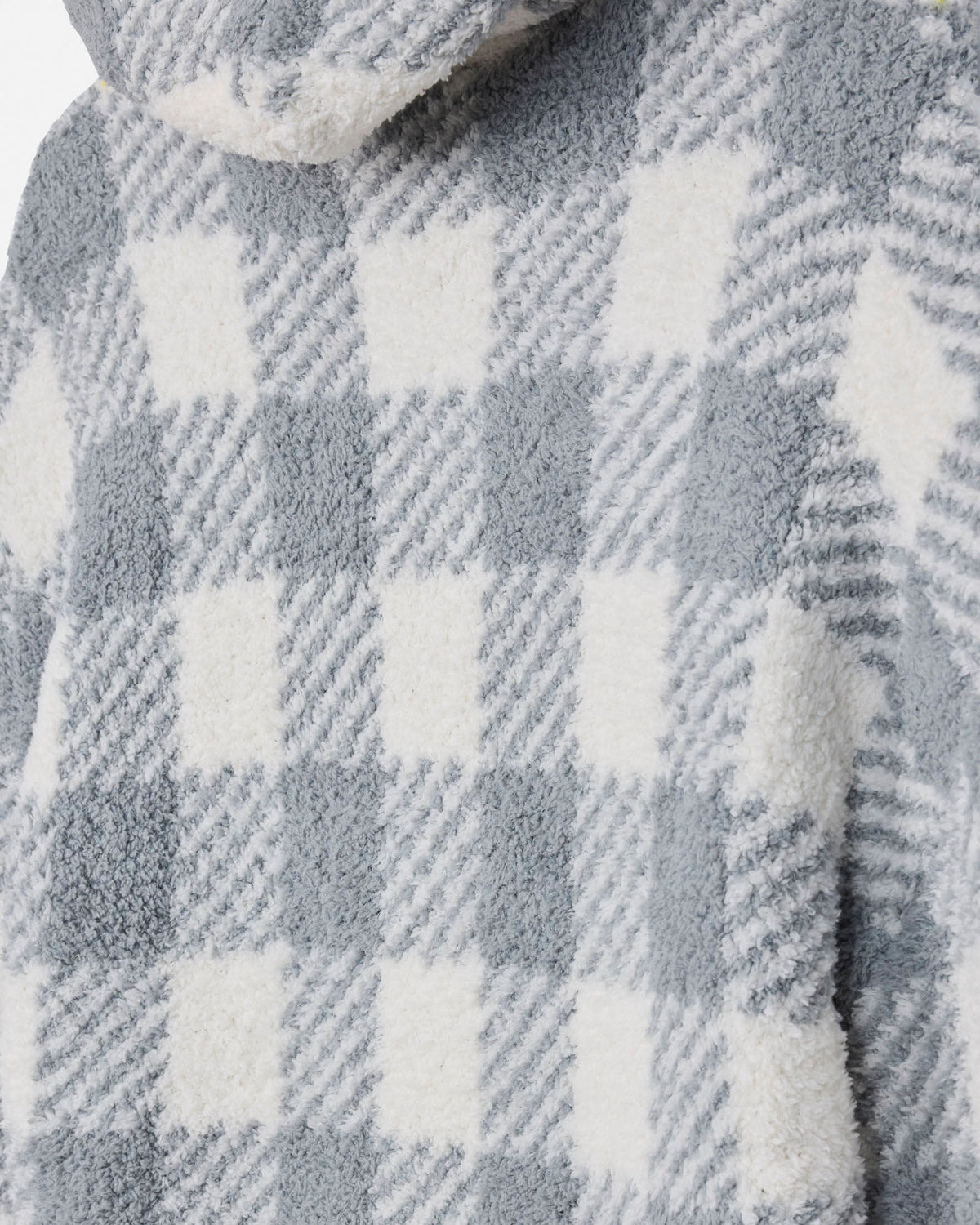 Close-up of a plush fleece garment with a gray and white gingham plaid pattern.