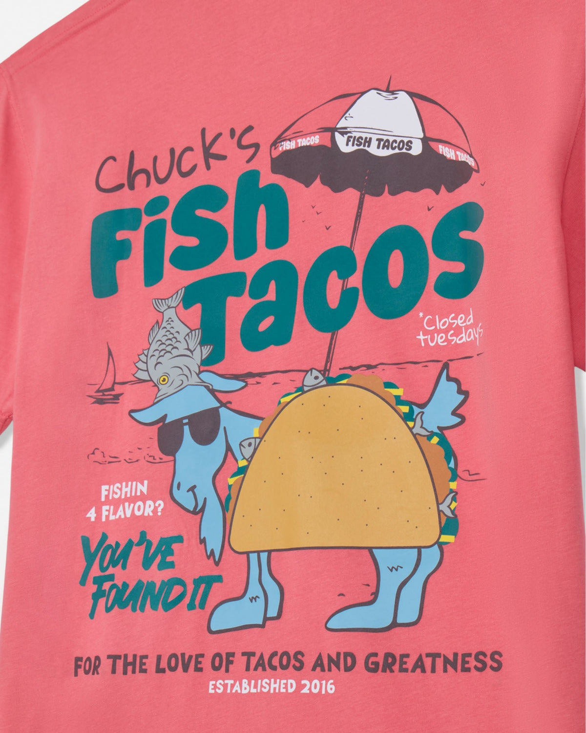 Pink t-shirt with 'Chuck's Fish Tacos' graphic design on a white background