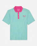 Mint green polo shirt with pink collar and logo on a white background