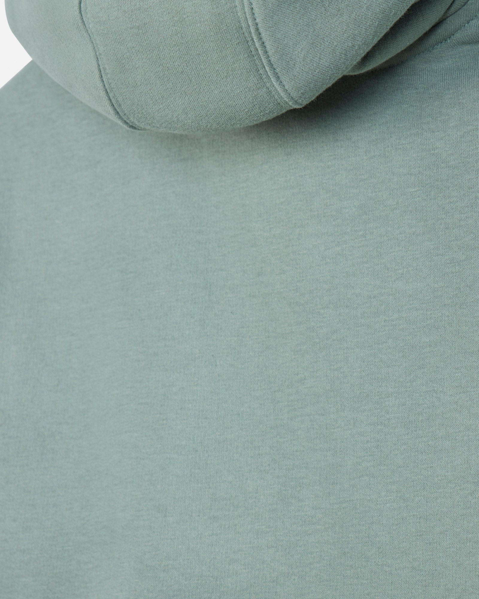 Close-up of a sage green hooded sweatshirt showing the fabric texture and hood seam.