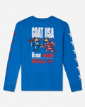 A bright blue long-sleeve t-shirt with a detailed graphic on the back. The graphic features cartoon goats playing football, with the text 'GOAT USA' in white above and 'GOAT FREEDOM' below, flanked by red and white stars on the sleeves.