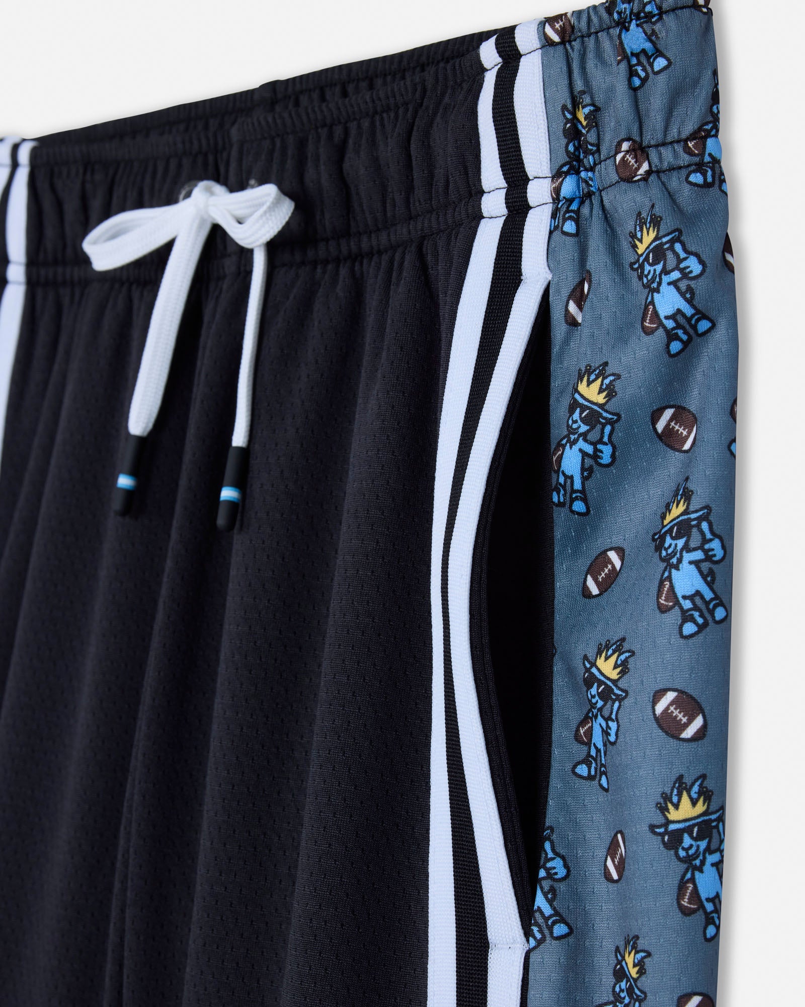Black shorts with white drawstring and blue shorts with cartoon character pattern on a white background