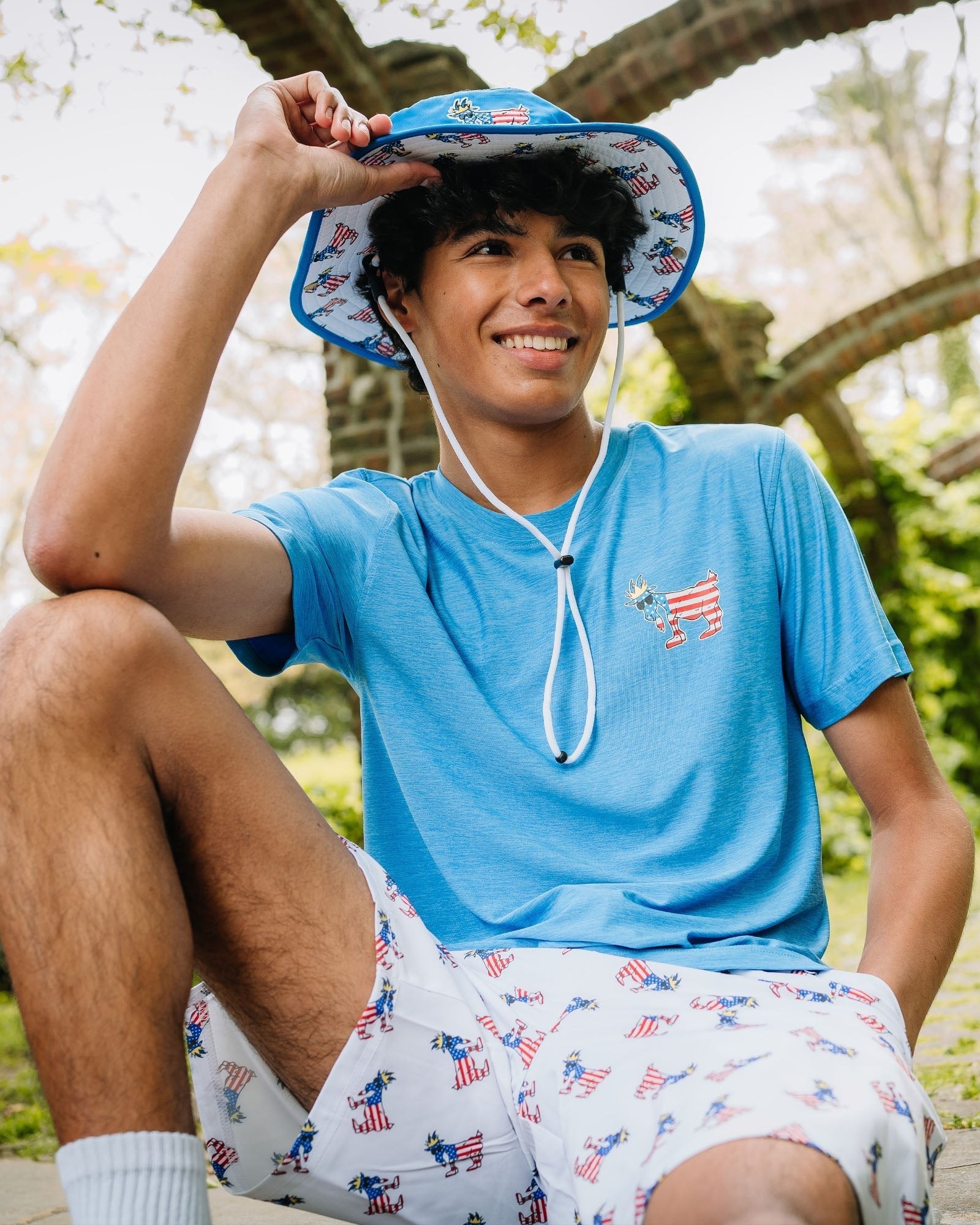 Kid wearing royal athletic t-shirt in a garden#color_royal