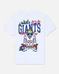 White short-sleeve crewneck t-shirt featuring a New York Giants themed graphic on the front. The graphic includes a blue goat mascot wearing a gold crown and sunglasses, seated on a bench with a football helmet, under the text 'Let's Go GIANTS' and 'LET'S GO!'.