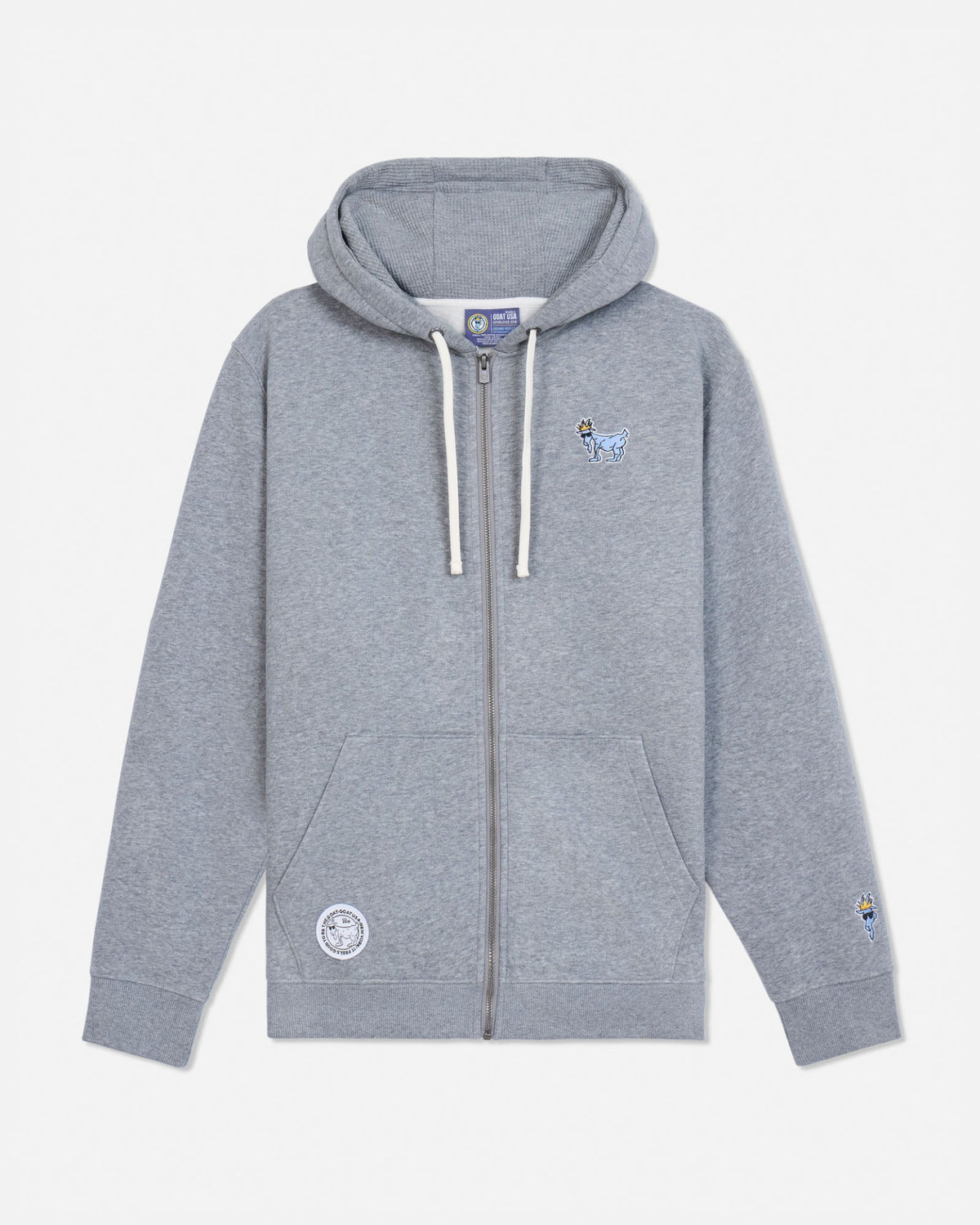 A light gray heather zip-up hoodie with white drawstrings, featuring a small embroidered blue goat on the left chest and a circular embroidered patch on the right sleeve, displayed against a clean off-white background.#color_gray-heather