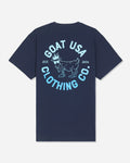 A navy blue short-sleeve t-shirt shown from the back, featuring a large light blue graphic print with a goat illustration and the text 'GOAT USA CLOTHING CO.' and 'EST.