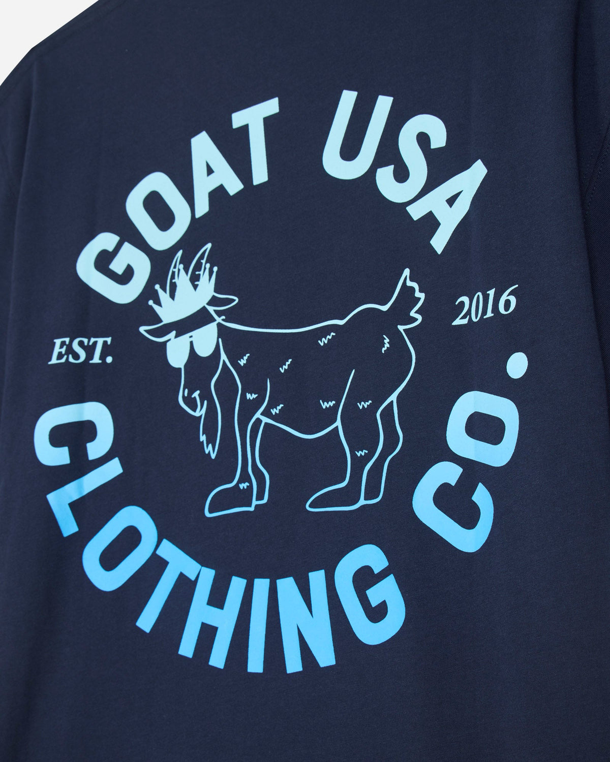 Close-up of blue ombre graphic on the back of navy t-shirt