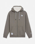 A taupe-brown full-zip hoodie with a cream sherpa-lined hood, featuring a small white graphic on the left chest, a circular patch on the lower left front pocket, and a small graphic on the right sleeve cuff.#color_smokey-olive