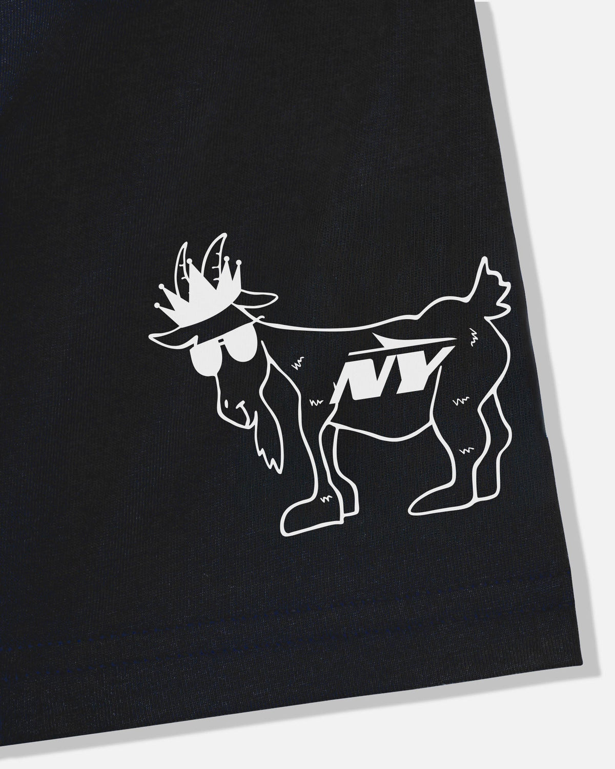 A close-up of a black garment featuring a white line-art graphic of a goat wearing sunglasses and a hat, with the letters 'NY' printed on its side.