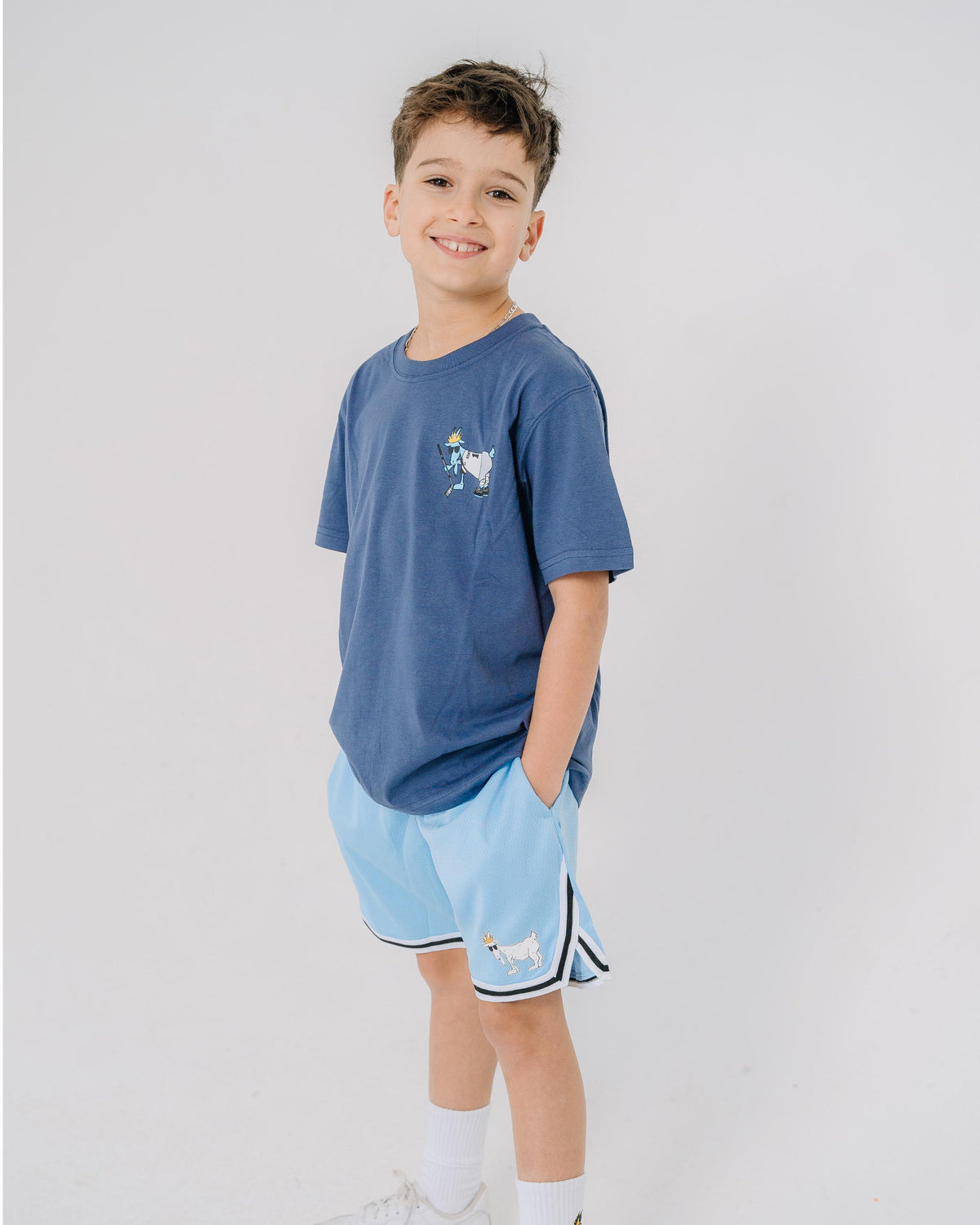 Kid wearing carolina blue mesh shorts with black and white waistband