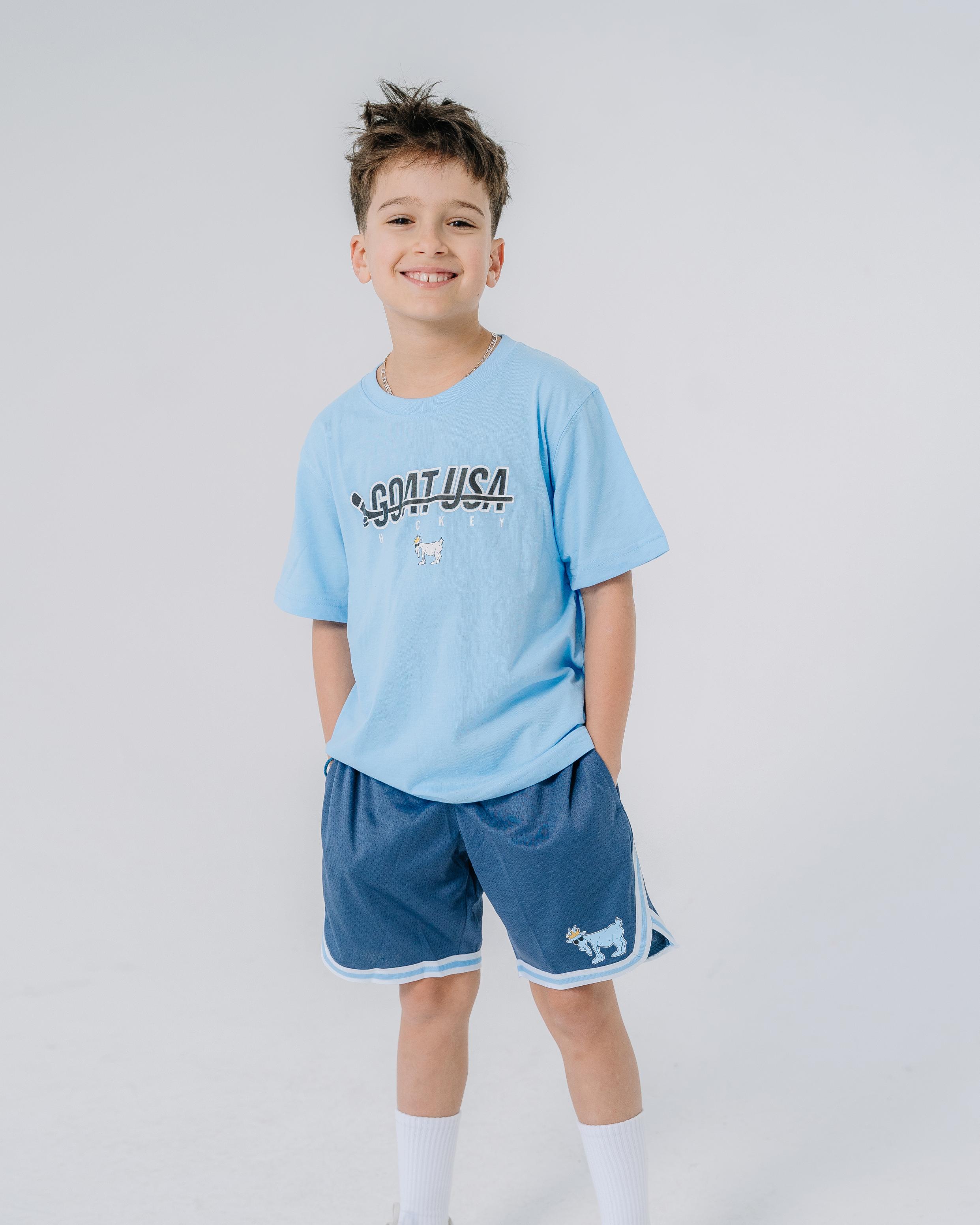 Kid wearing navy mesh shorts with blue and white waistband#color_navy