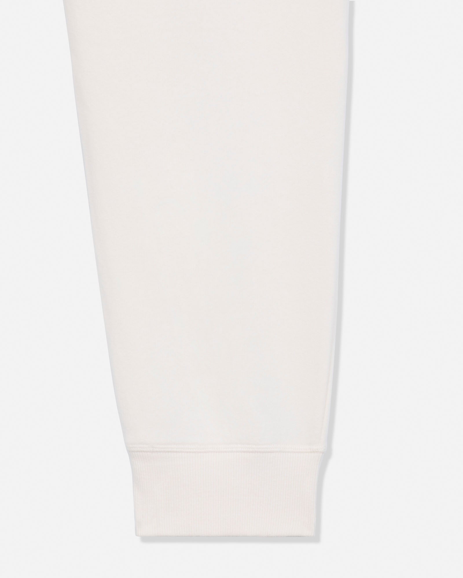 A close-up of a light cream or off-white fabric sleeve or cuff with a ribbed hem, shown against a very light gray background.#color_bone