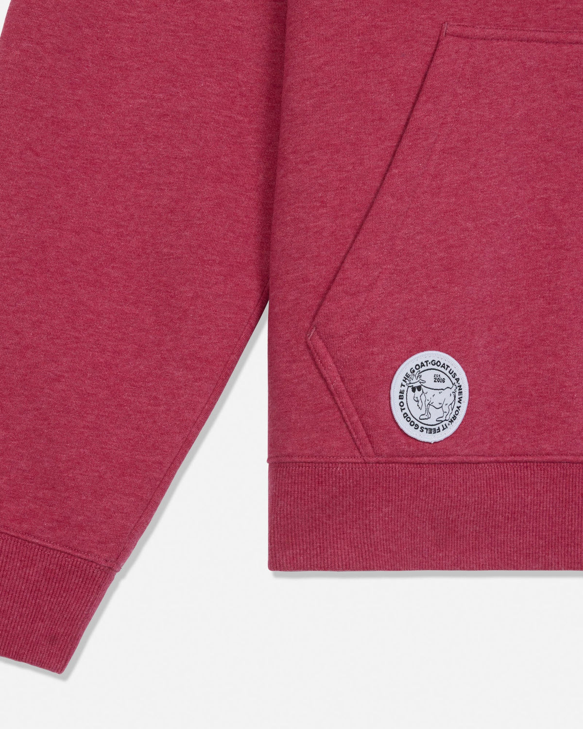 Close-up of pocket and embroidered patch on hooded sweathshirt