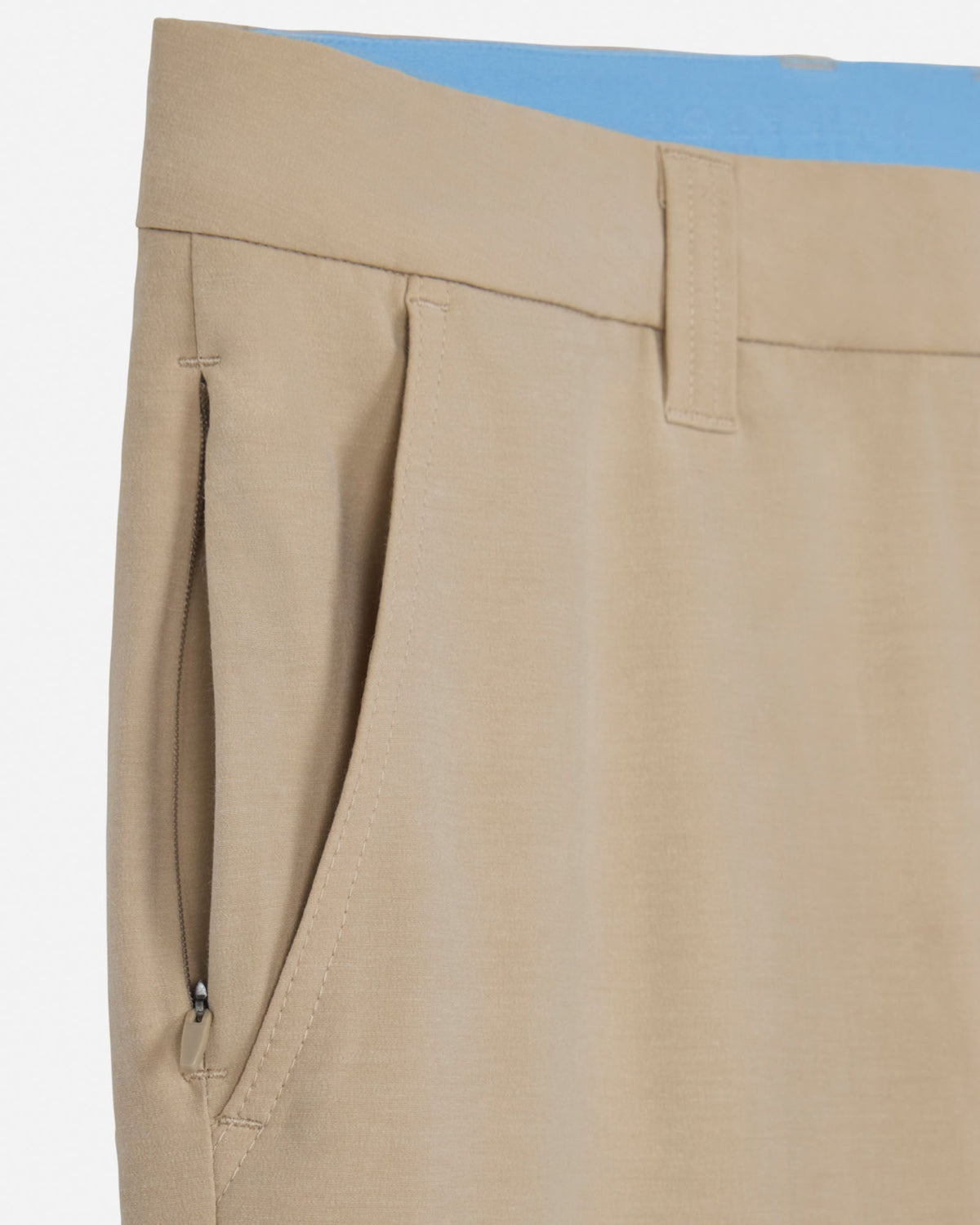 Close-up of beige pants with a white background
