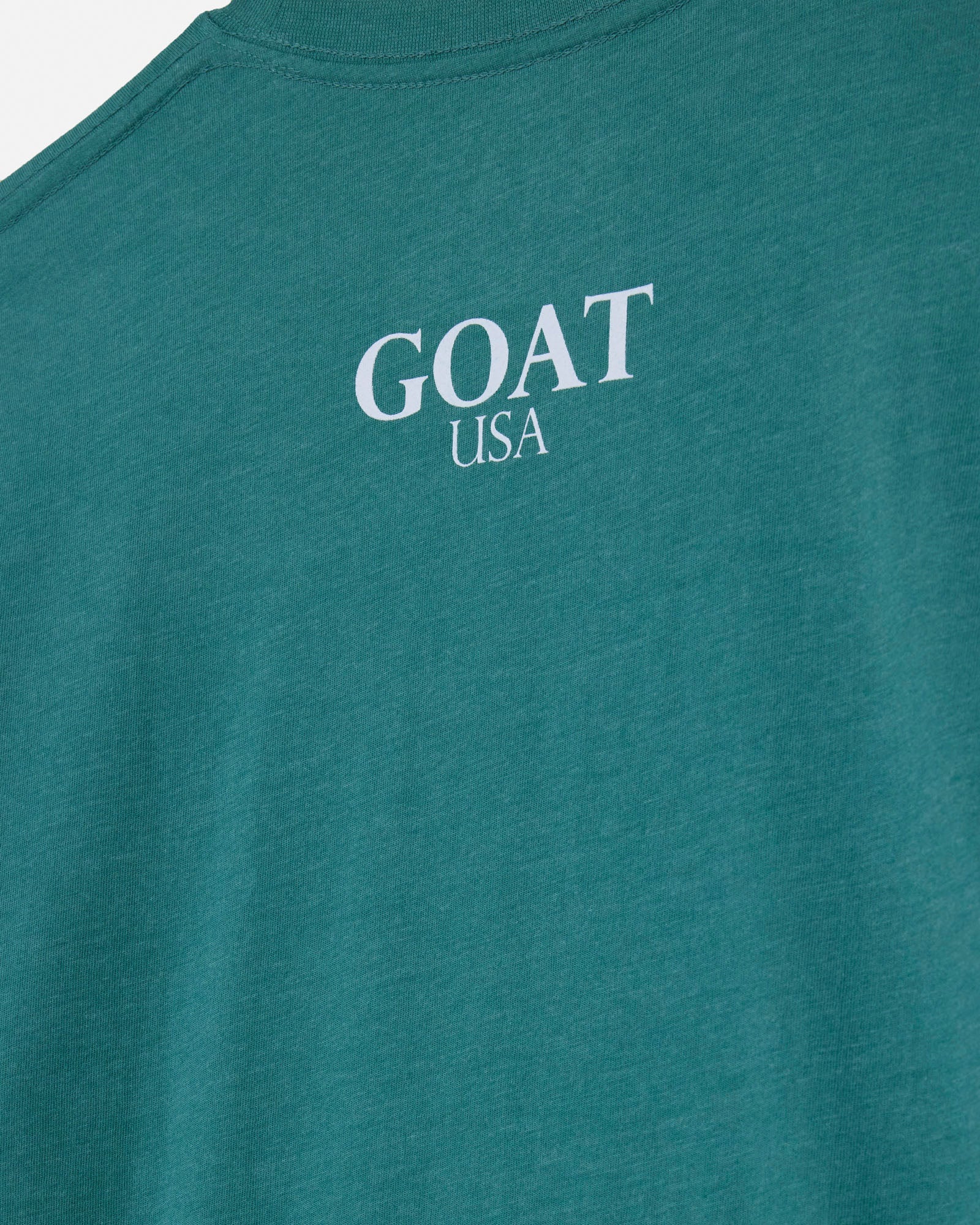 Teal t-shirt with 'GOAT USA' text on a white background#color_deep-sea