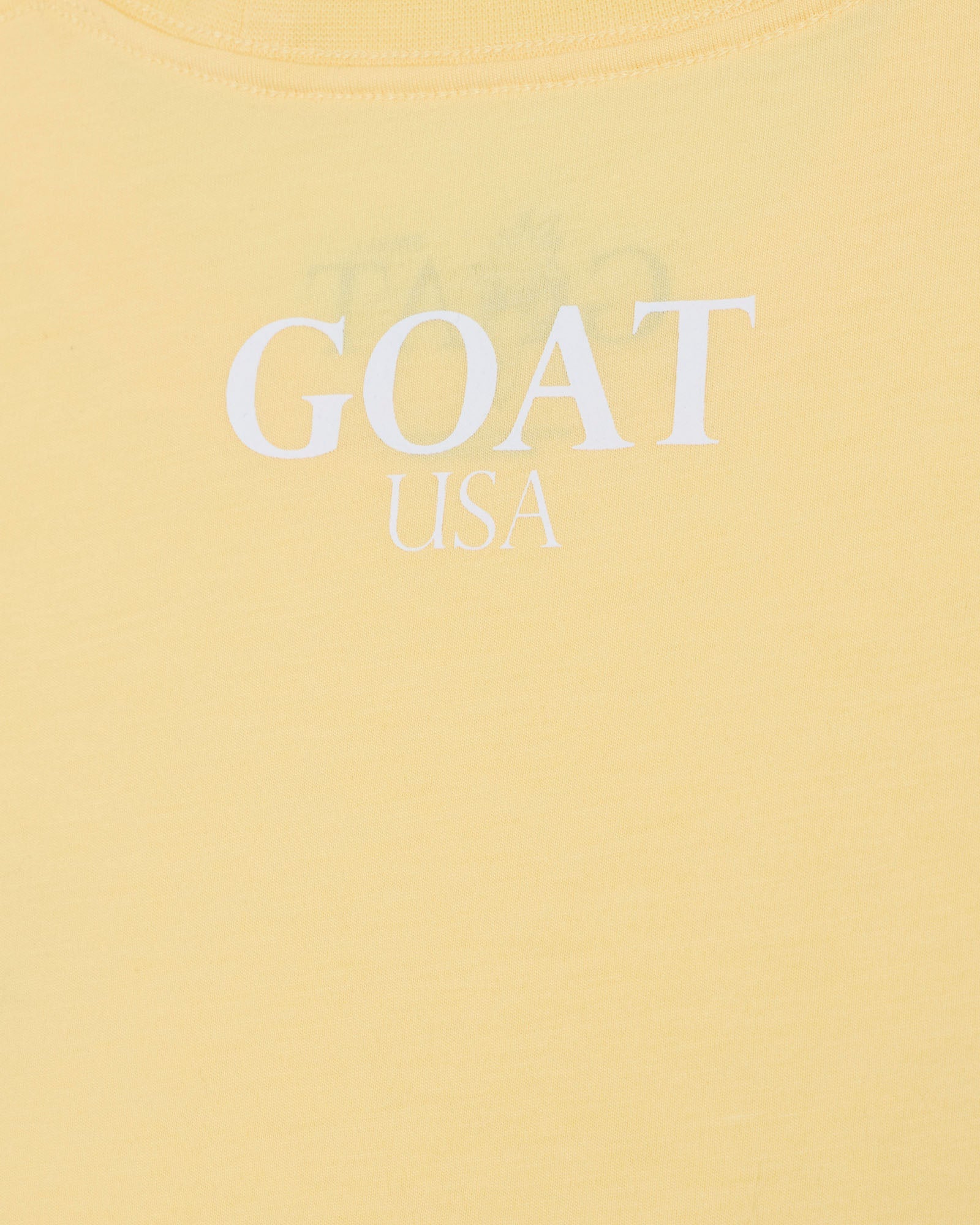 Yellow t-shirt with 'GOAT USA' text on a yellow background#color_corn-milk