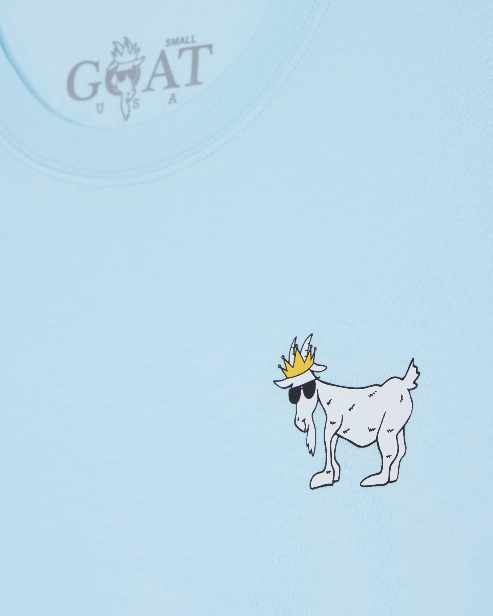Light blue t-shirt with a cartoon goat wearing a crown on a light blue background.#color_delicate-blue