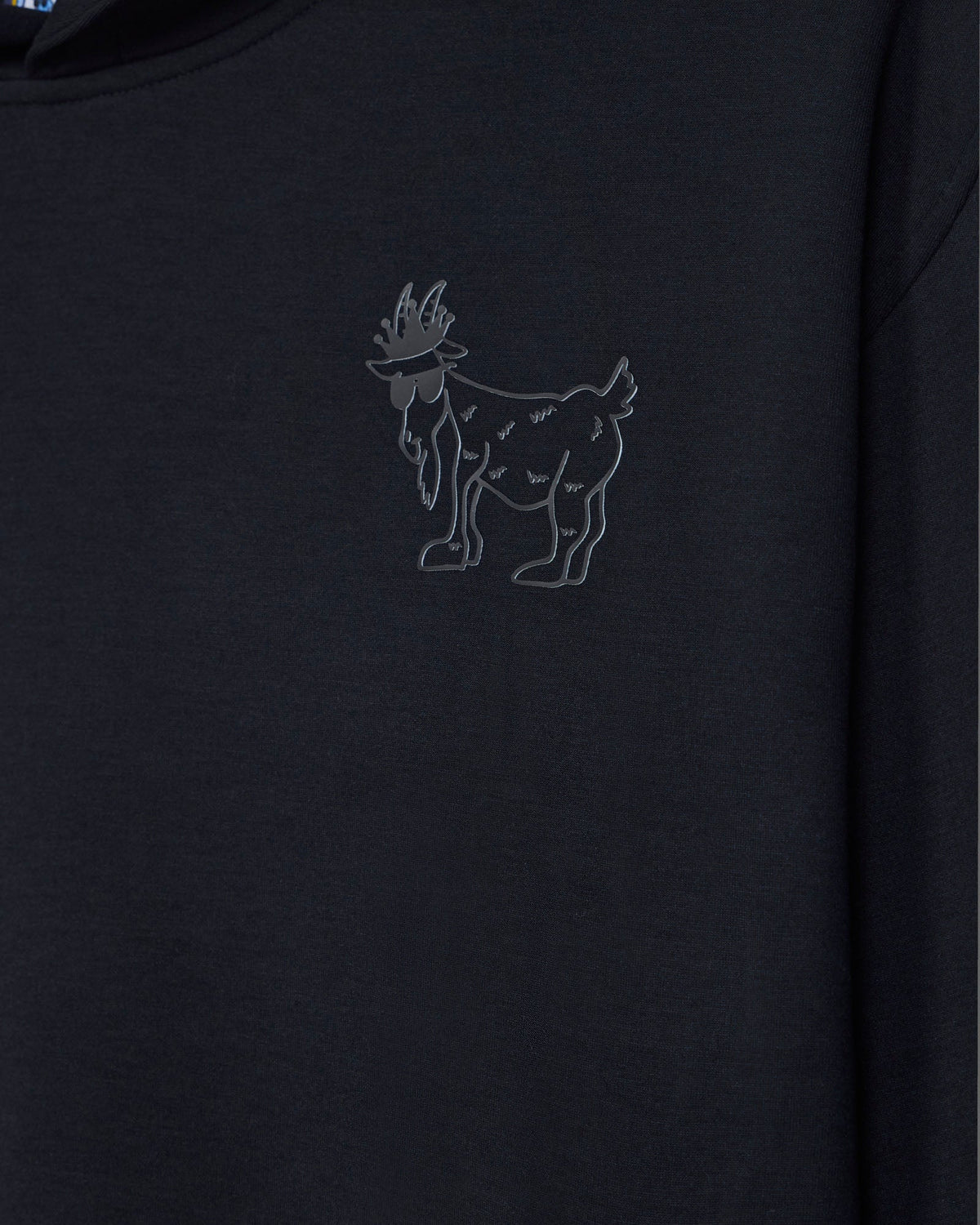 Close-up of outline logo on black hoodie made with athletic material