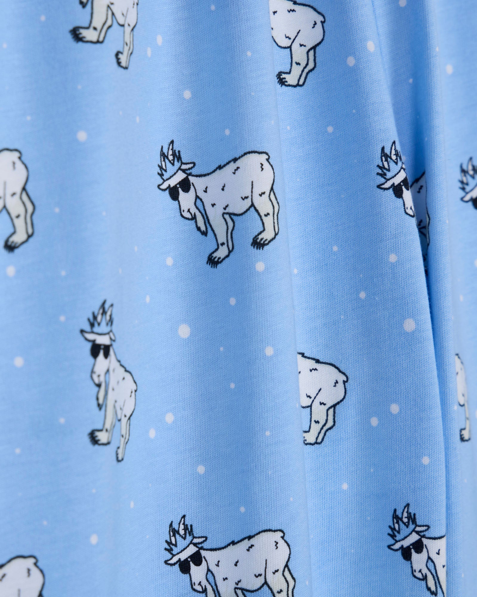 Pattern of cartoon-like animals on a blue background with white dots.
