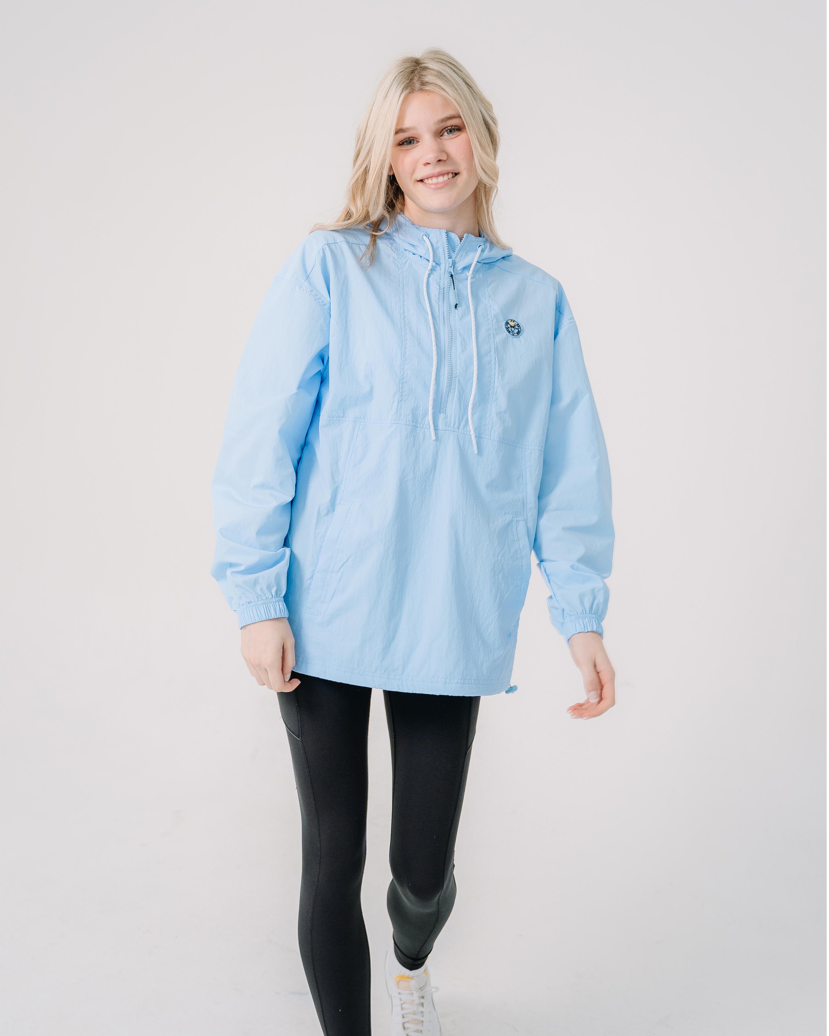Girl wearing carolina blue windbreaker#color_carolina-blue