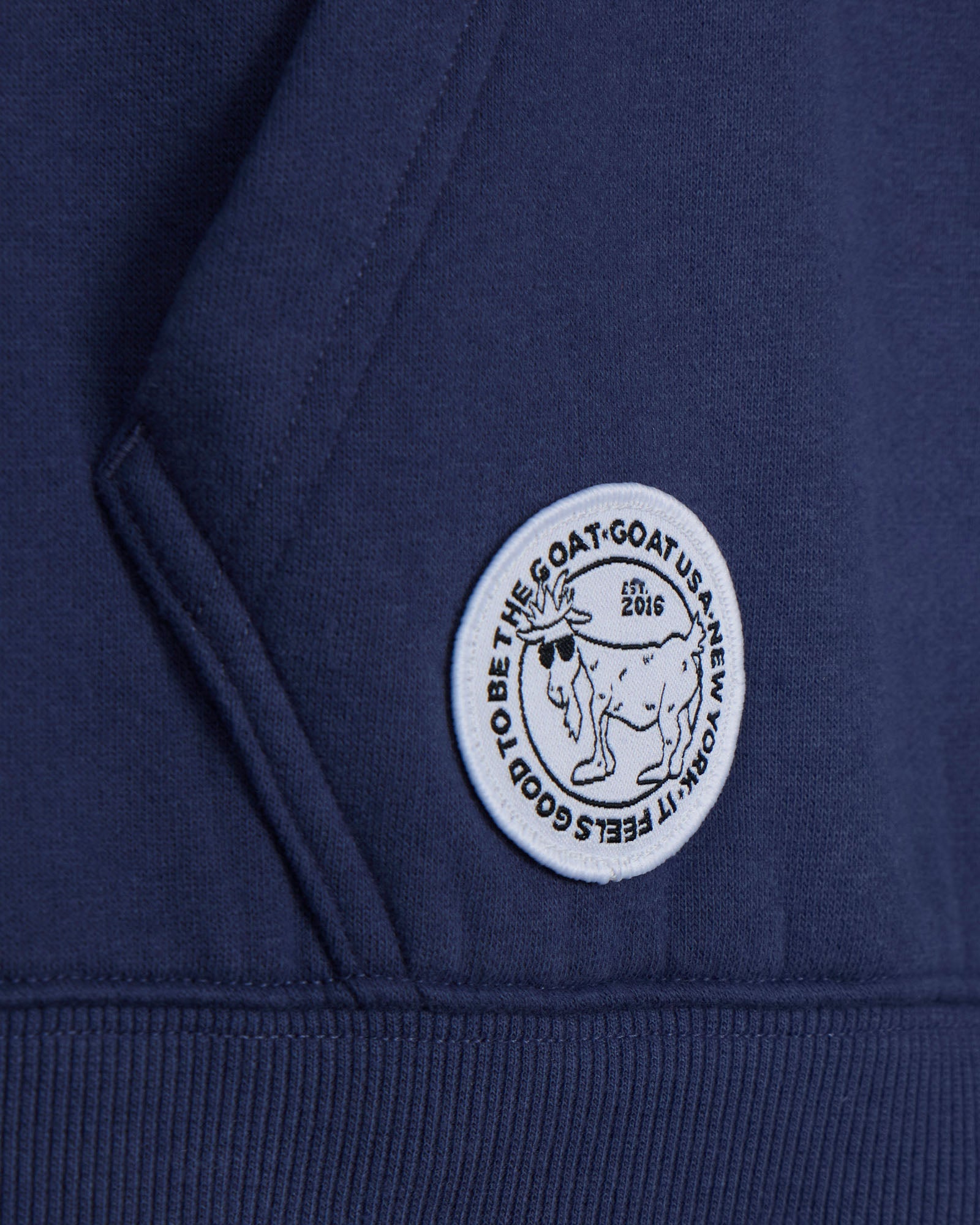 Navy blue hoodie with a white logo on the chest