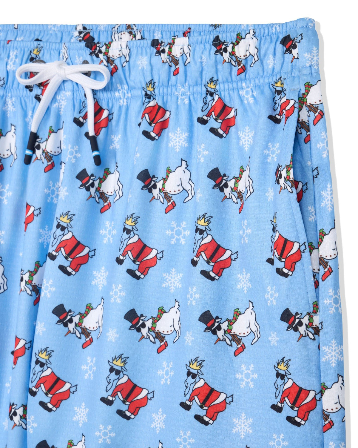 Light blue drawstring shorts featuring an all-over print of cartoon snowman and santa-like figures in red and white, with white snowflake motifs