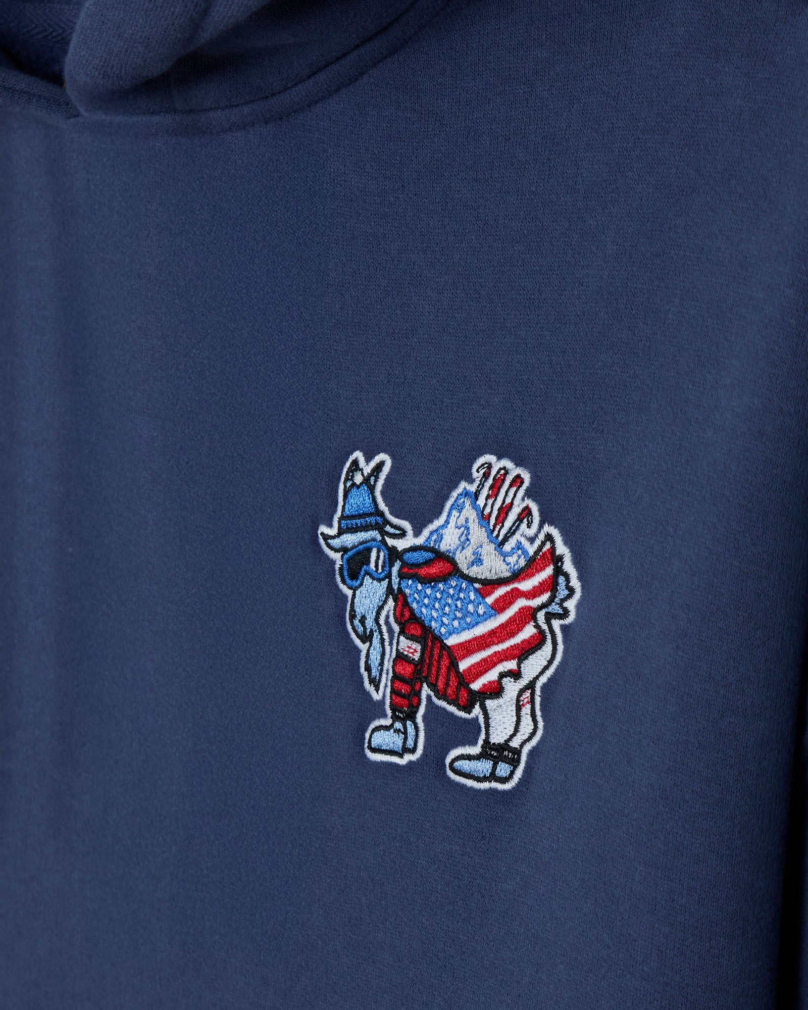Navy blue hoodie with a embroidered patch of a goat holding an American flag on a navy background