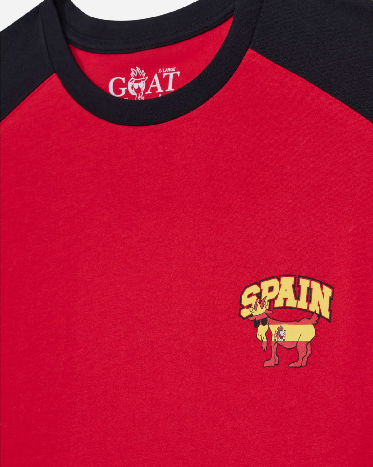 Red shirt with black collar featuring a 'Spain' logo and goat emblem.