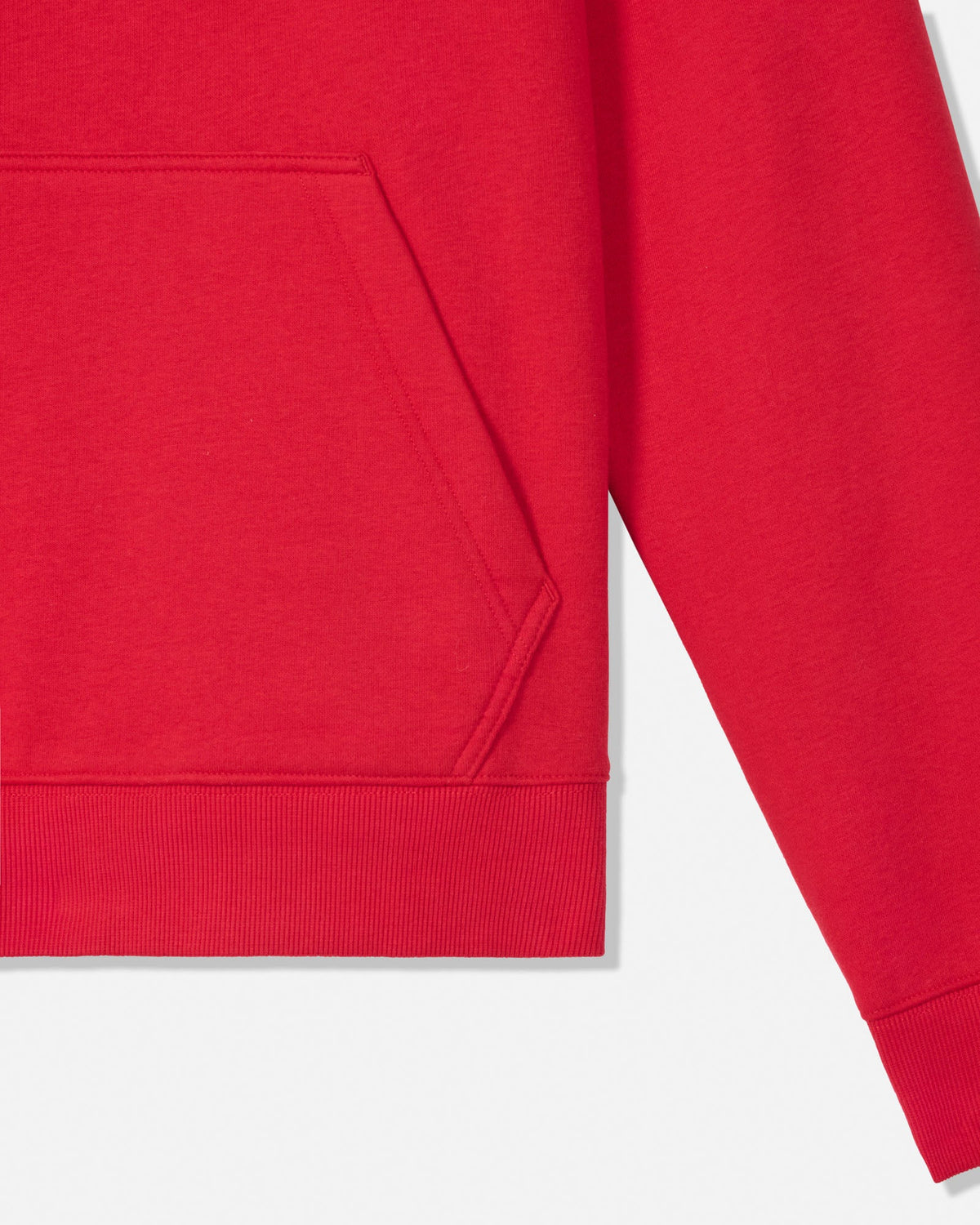 Close-up of a bright red sweatshirt showing the sleeve, ribbed cuff, and part of the front pocket on a light gray background.
