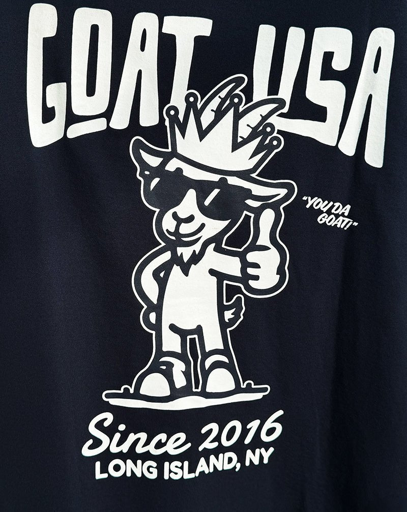 Navy t-shirt with white graphic and text 'GOAT USA' and 'Since 2016 LONG ISLAND, NY'.