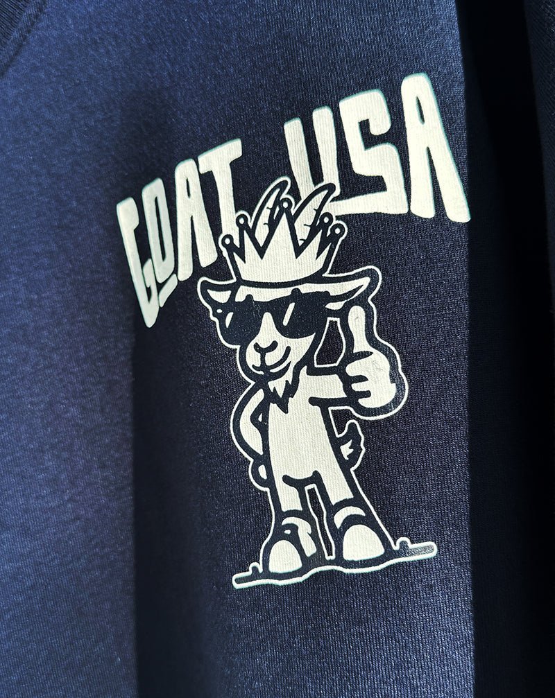 Navy blue t-shirt with 'GOAT USA' logo featuring a goat giving a thumbs up.