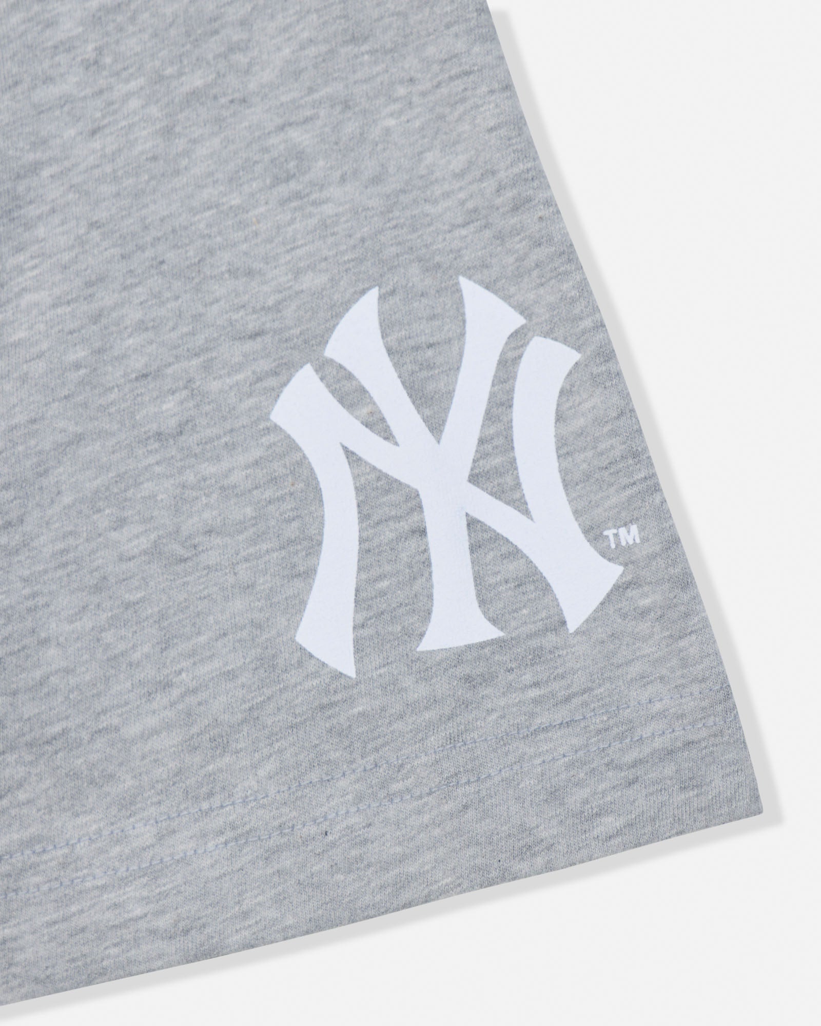 Close-up of a heather gray fabric product featuring a large white New York Yankees interlocking NY logo on the front.