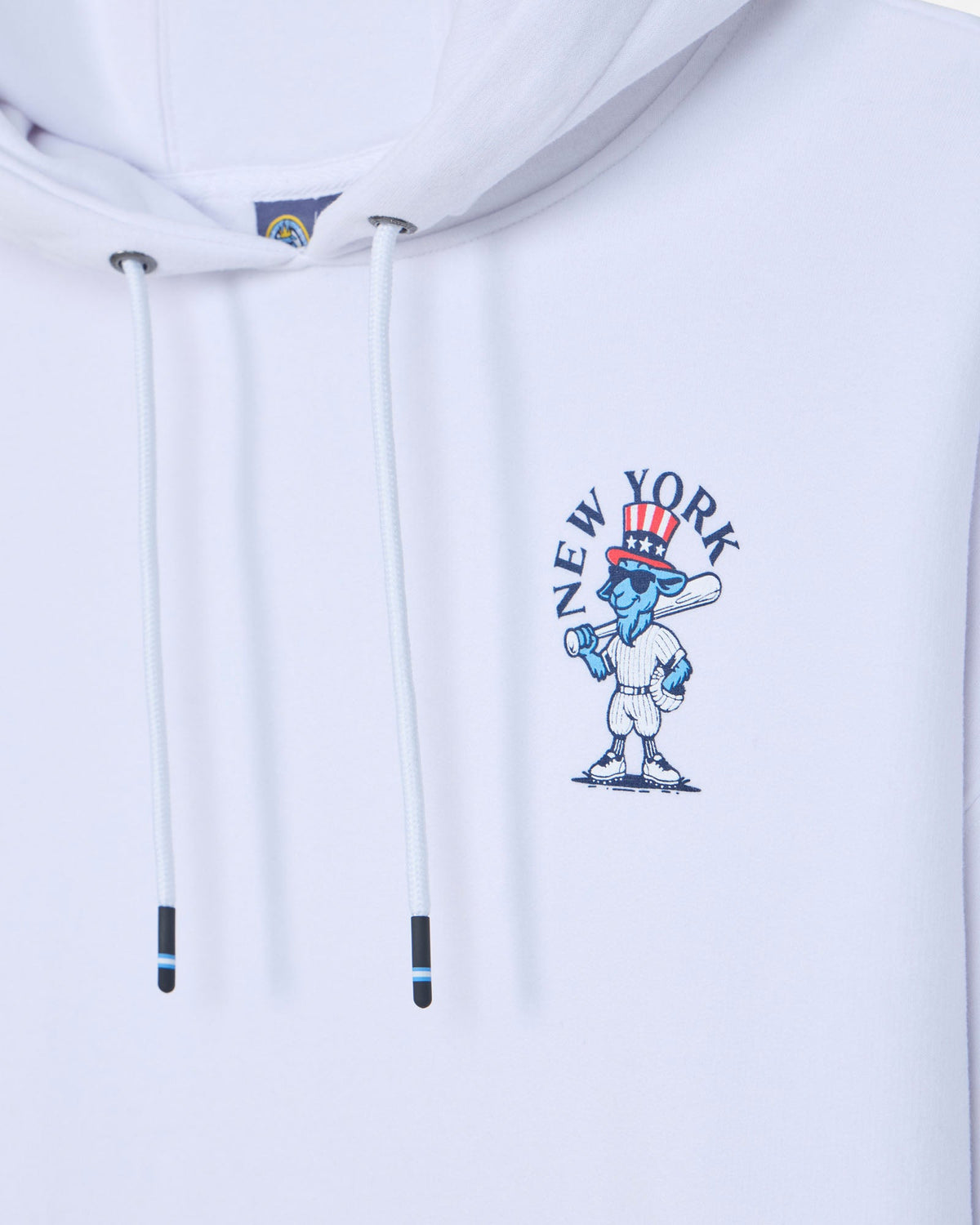 Close-up of a white pullover hoodie with white drawstrings and a blue, red, and white New York City graphic on the chest.