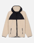 Two-tone sherpa jacket with beige front and black hood on a light gray background