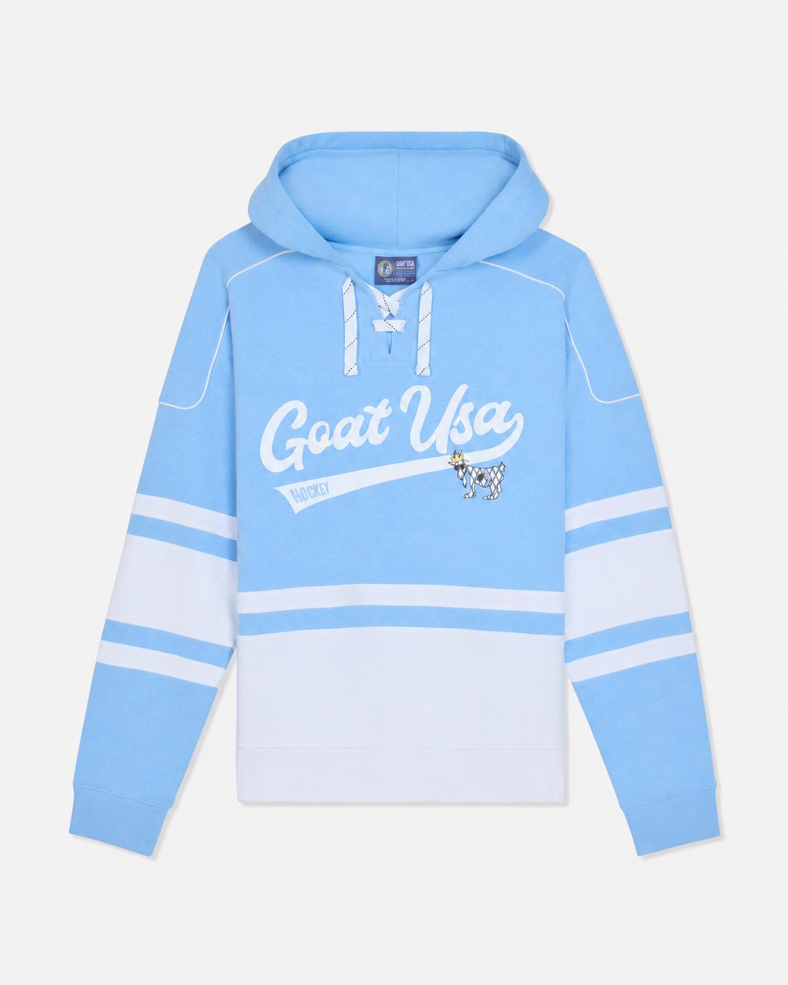 A light blue and white hooded sweatshirt with 'GOAT USA' printed in white script across the chest, featuring a small cow graphic and horizontal white stripes on the sleeves.